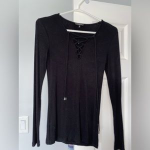 Long sleeve black top with criss cross front detail.